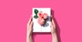 Female hands holding a gift box with pink roses Royalty Free Stock Photo