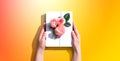 Female hands holding a gift box with pink roses Royalty Free Stock Photo