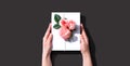 Female hands holding a gift box with pink roses Royalty Free Stock Photo