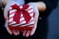 Female hands holding a gift box, present. Royalty Free Stock Photo