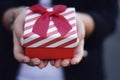 Female hands holding a gift box, present. Royalty Free Stock Photo