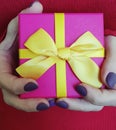 Female hands holding a gift box present decoration anniversary celebration Royalty Free Stock Photo