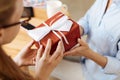 Female hands holding a gift box