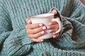 Female hands holding hot cup of coffee or tea Royalty Free Stock Photo