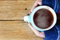 Female hands holding hot tea mug on winter time