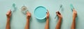 Female hands holding kitchen tools, sieve, rolling pin, plate, sieve, brush, whisk, spatula for baking and cooking over pastel