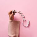 Female hands holding measuring tape over pink background. Top view, flat lay. Sweet, dessert, diet concept. Banner with copy space Royalty Free Stock Photo