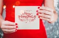 Female hands holding Merry Christmas card or letter to Santa. Xmas and New Year theme. Royalty Free Stock Photo