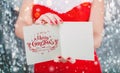 Female hands holding Merry Christmas card or letter to Santa. Xmas and New Year theme. Royalty Free Stock Photo