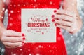Female hands holding Merry Christmas`s card or letter to Santa. Royalty Free Stock Photo
