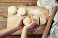 Female Hands Holding and mixing Dough for baking pie, or pizza. Homemade Preparing Food. Top view. Rustic background. Royalty Free Stock Photo