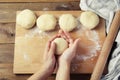 Female Hands Holding and mixing Dough for baking pie, or pizza. Homemade Preparing Food. Top view. Rustic background. Royalty Free Stock Photo