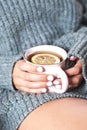 Female hands holding mug of hot tea with lemon in morning. Young woman relaxing tea cup on hand Royalty Free Stock Photo