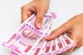 Female hands holding new 2000 indian rupees banknotes