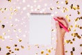 Female hands holding notebook with empt copy space on festive confetti background