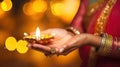 Female hands holding oil lamp celebrating Diwali, beautiful lights bokeh background. Generative AI