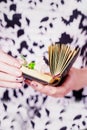 Female hands holding old book and pink carnation flower on a black white background Royalty Free Stock Photo