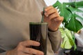 Female hands holding Organic blue-green algae spirulina detox drink in glass powder food. Health protein cocktail Royalty Free Stock Photo