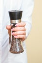 Pepper mills in female hands Royalty Free Stock Photo