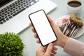 Female hands holding phone with isolated screen above the table Royalty Free Stock Photo