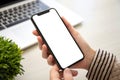 Female hands holding phone with isolated screen in the office Royalty Free Stock Photo