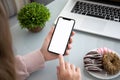 Female hands holding phone with isolated screen in the office Royalty Free Stock Photo