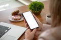 Female hands holding phone with isolated screen in the office Royalty Free Stock Photo