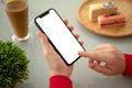 Female hands holding phone with isolated screen in a cafe Royalty Free Stock Photo
