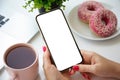 Female hands holding phone with isolated screen over table cafe Royalty Free Stock Photo