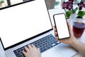 Female hands holding phone typing laptop computer keyboard isolated screen Royalty Free Stock Photo