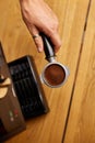 Male barista hand making espresso from ground coffee maker at modern cafe Royalty Free Stock Photo