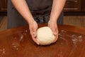 Female hands holding raw dough for homemade bread. home kitchen