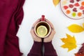 Female hands holding red cup of tee with limon slices. Seasonal autumn warming drink Royalty Free Stock Photo