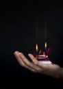 Female hands holding a red double flamed flat candle Royalty Free Stock Photo