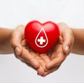 Female hands holding red heart with donor sign Royalty Free Stock Photo