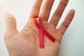 Female hands holding red ribbon HIV, AIDS awareness ribbon, healthcare and medicine concept Royalty Free Stock Photo