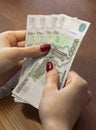 Female hands holding Russian banknotes of one thousand rubles