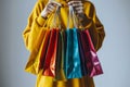 Female hands holding and showing colorful shopping bags Royalty Free Stock Photo