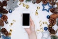 Female hands holding smart mobile phone on white background with Royalty Free Stock Photo