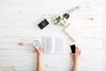 Female hands holding smartphone and water glass Royalty Free Stock Photo