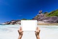 Female hands holding tablet taking pictures Similan islands, Beautiful view of the rock Sail, Thailand Royalty Free Stock Photo