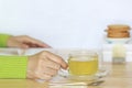 Female hands holding tea cup and open read  on the table Royalty Free Stock Photo