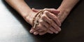 Female hands holding tight a Christian cross