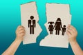 Female hands holding a torn poster separating the symbol of a man and a woman with children, the concept of a breakup, divorce, Royalty Free Stock Photo