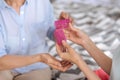 Female hands holding two pink hair rollers Royalty Free Stock Photo