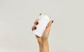 Female hands holding white deodorant. Isolated on gray background. Closeup Royalty Free Stock Photo