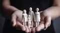 Female hands holding white family figures, generative ai Royalty Free Stock Photo