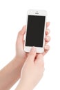 Female hands holding white modern smart phone and pressing button by the thumb