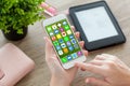 Female hands holding white phone with home screen icons apps Royalty Free Stock Photo