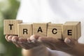 Female hands holding wooden cubes, blocks word TRACE. Conceptual image about human rights, education, social issues Royalty Free Stock Photo